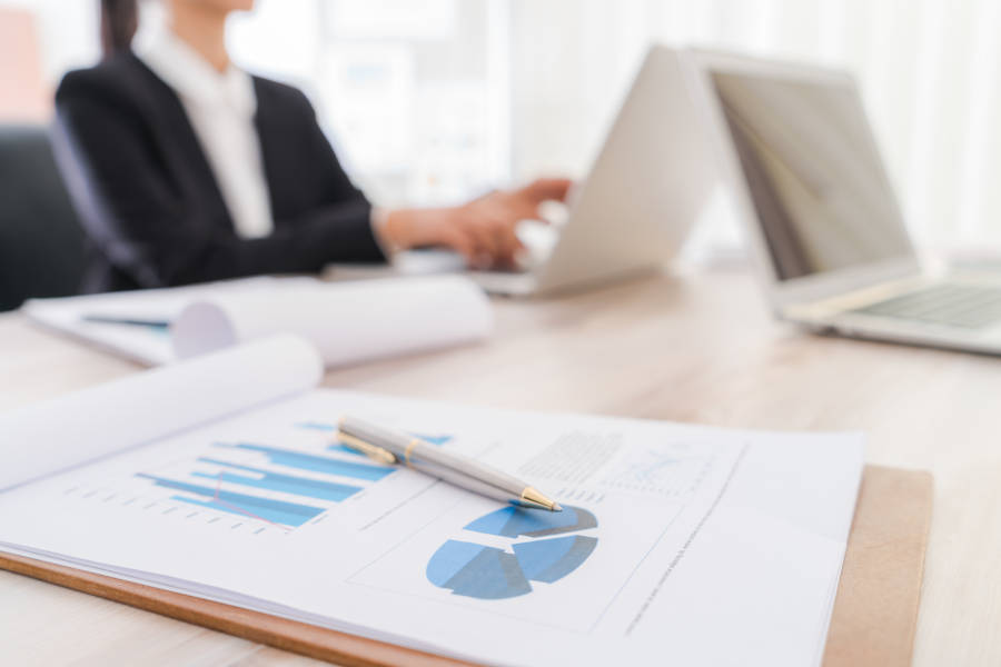 Business people using laptop and Financial charts at meeting o